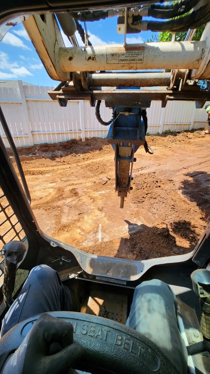 Equipment performing excavation and rough grading along future driveway route