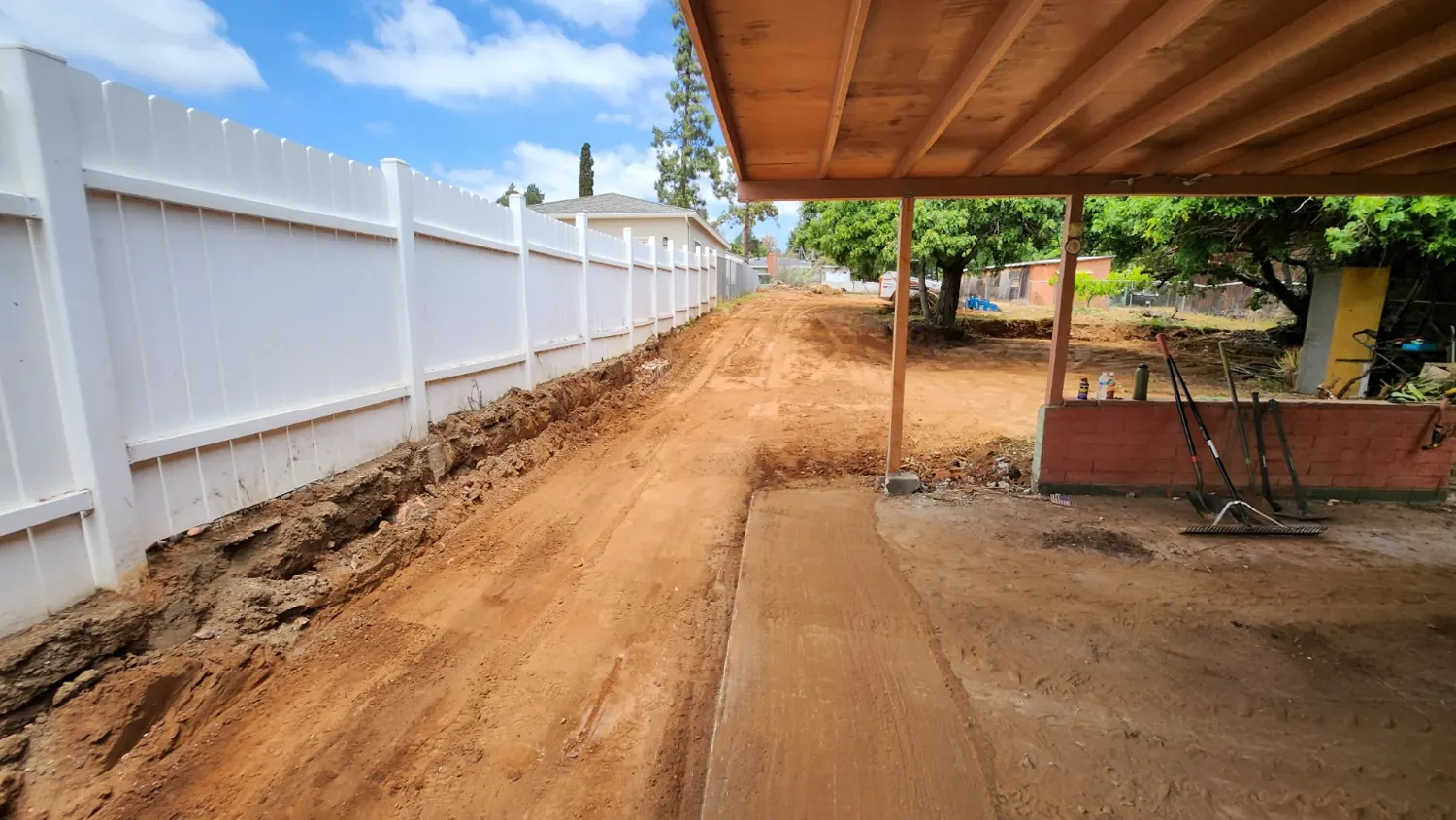 Partially graded access corridor with remaining rough soil