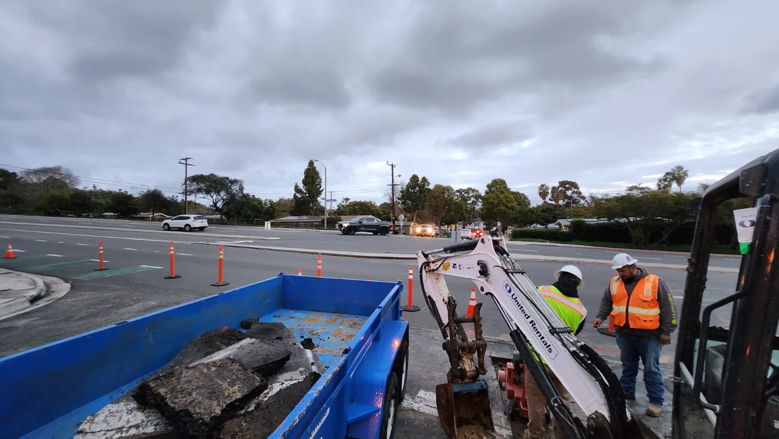 Crew and traffic controls at roadway repair site