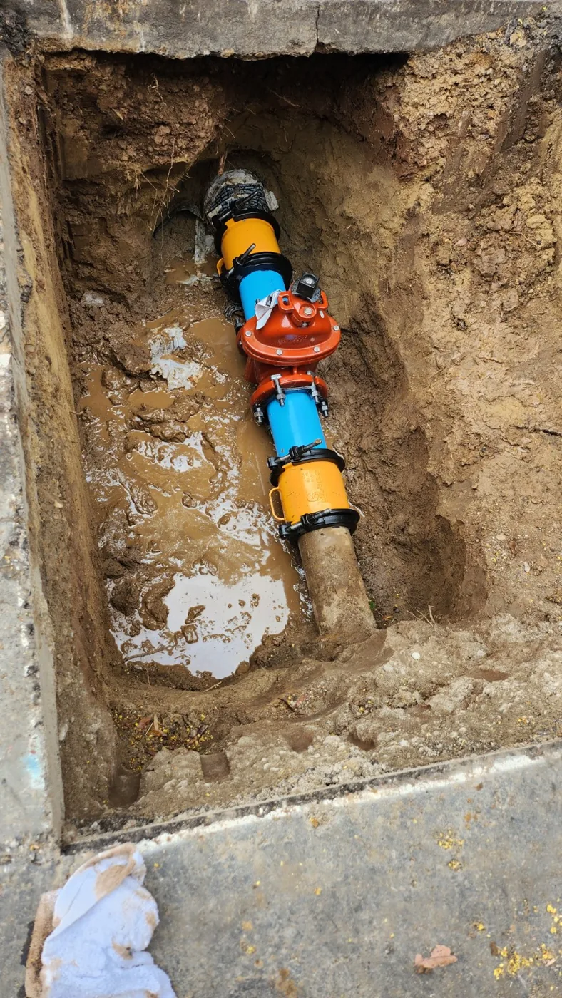 Valve and bolted coupling installation detail within excavation