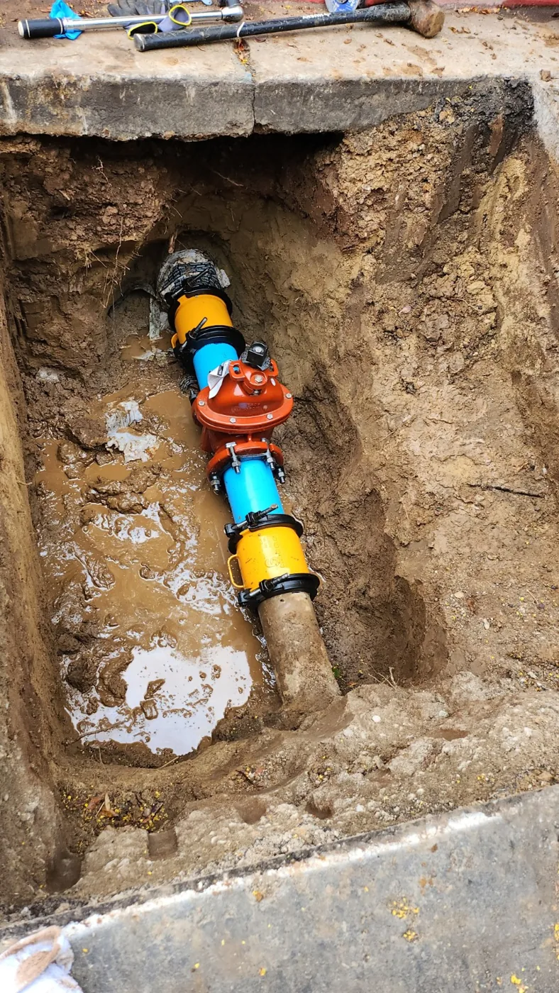 New water distribution valve and couplings installed in excavated trench